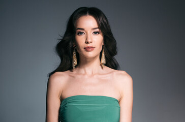 Obraz premium Beautiful woman with long hair, shine and curly, beauty girl female over darl gray background