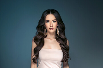 Beautiful woman with long hair, shine and curly, beauty girl female over darl gray background