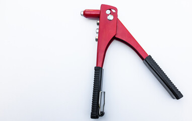 Red color tool for riveting aluminum rivets in the material. On white isolate