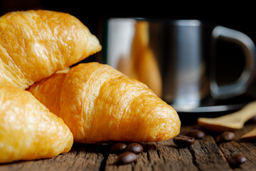 Close up of pile of delicious croissants on a dark background.