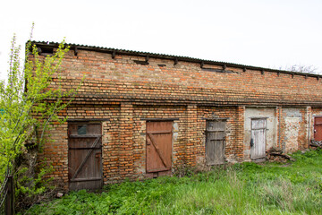 Fototapeta na wymiar Old brick outbuildings of the soviet union in the Kirovograd region