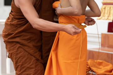 The monk is wearing the robe to the newly ordained monks in the temple, during the Buddhist...