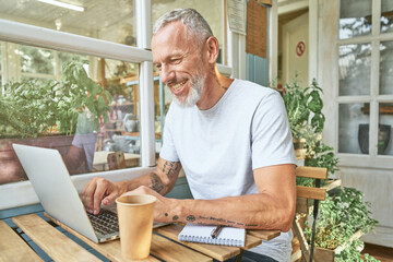 Middle aged caucasian man next to laptop