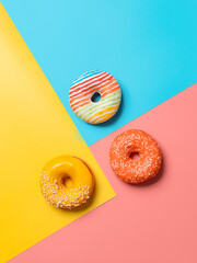 Creative layout made from delicious glazed donuts. Vertical flat lay - donuts or doughnuts on...