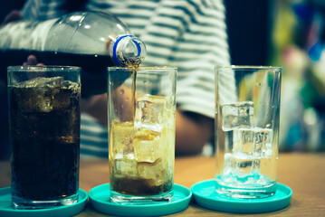 Refreshing Bubbly Soda Pop with Ice Cubes. Cold soda iced drink in a glasses - Selective focus, shallow DOF	
