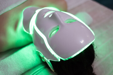 Woman with led light therapy facial and neck beauty mask photon therapy. Home skincare and me time...