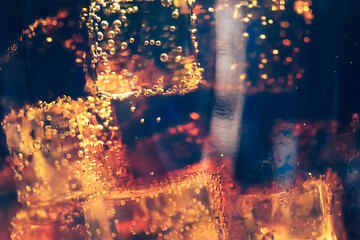Refreshing Bubbly Soda Pop with Ice Cubes. Cold soda iced drink in a glasses - Selective focus,...