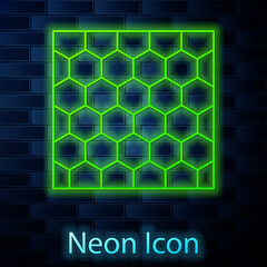 Glowing neon line Honeycomb icon isolated on brick wall background. Honey cells symbol. Sweet natural food. Vector