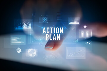 Finger touching tablet with business graphs and icons concept