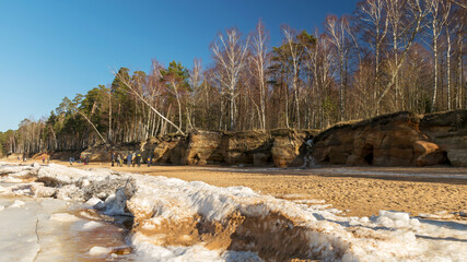 landscape with Veczemju cliffs, which are the most impressive and colorful group of sandstone cliffs on the coast of Vidzeme, ice cubes cover the dune area, Latvia