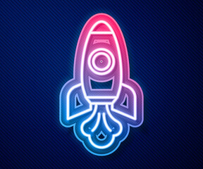 Glowing neon line Rocket ship icon isolated on blue background. Space travel. Vector