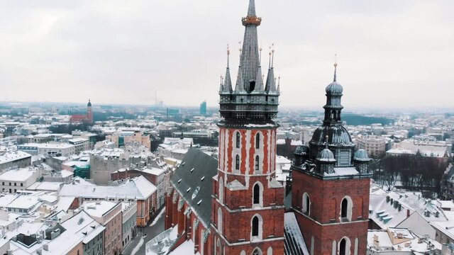 Aerial view of Old city center. Closeup of Adam Mickiewicz monument, St. Mary's Basilica in the city of Krakow, Poland. City skyline. Old buildings with a background of clear white sky. 