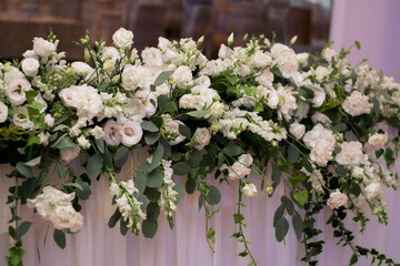 Main table at a wedding reception with beautiful fresh flowers