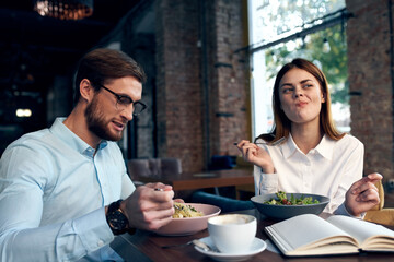 business man and woman sitting in a cafe snack communication lifestyle