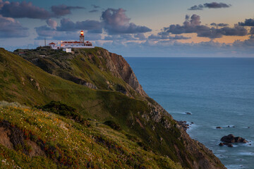 Fototapeta na wymiar Lighthouse at Cape Cabo da Roca near the city of Cascais, Portugal. Cape Roca is the most western point of continental Europe. 