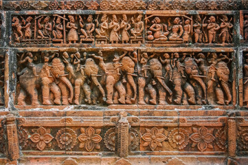 Beautiful terracotta carving scenes of palace life (top) and war elephants procession (bottom) at Kantaji aka Kantajew medieval hindu temple in Kantanagar, Dinajpur, Bangladesh