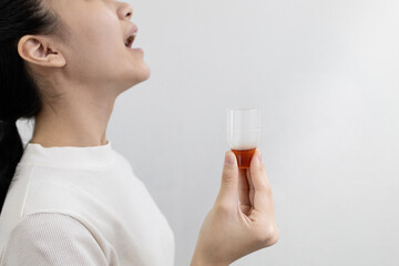 Asian lady girl rinsing the mouth or gargling with medicine of medical disinfectant,protect against...