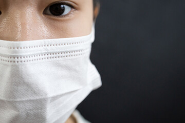 Asian lady girl in a face mask,disease prevention campaign,wearing protective face masks before leaving home,in the city street,public,community,prevent contagious or spreading Coronavirus COVID-19