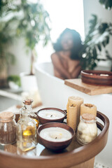 Dark-skinned woman relaxing in a bath and washing her body
