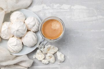 Fototapeta na wymiar cup of coffee with meringues on white dish