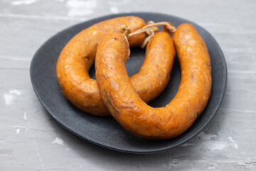 typical portuguese smoked sausage alheira on dark dish