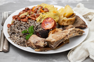 typical portuguese dish meat, smoked sausages and vegetables on the dish
