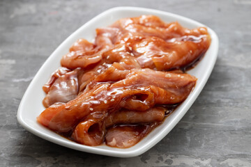 raw meat with sauce on white dish