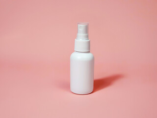 Front view and close-up of white plastic spray bottle mockup on pink background. Natural organic spa cosmetics and liquid antimicrobial spray concept