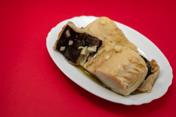 boiled cod fish with olive oil on white dish
