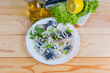Sliced salted Atlantic mackerel on dish on rustic table