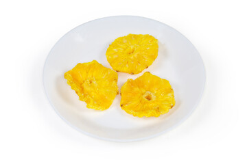 Dried pineapples slices on dish on a white background