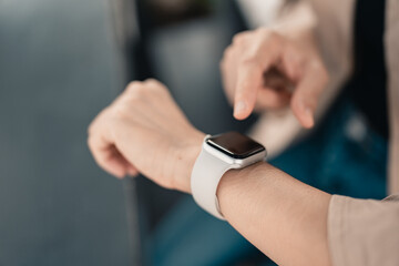 Woman using smart watches with checking pulse via health application. healthcare and people concept.