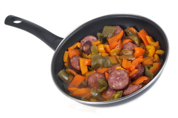 Poêlée de poivrons avec des rondelles de saucisse fumée en gros plan sur fond blanc