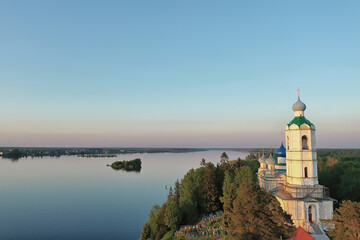 summer landscape in russia sunset, church on the banks of the river christianity orthodoxy