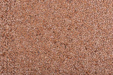 Background from a pile of natural flax seeds.