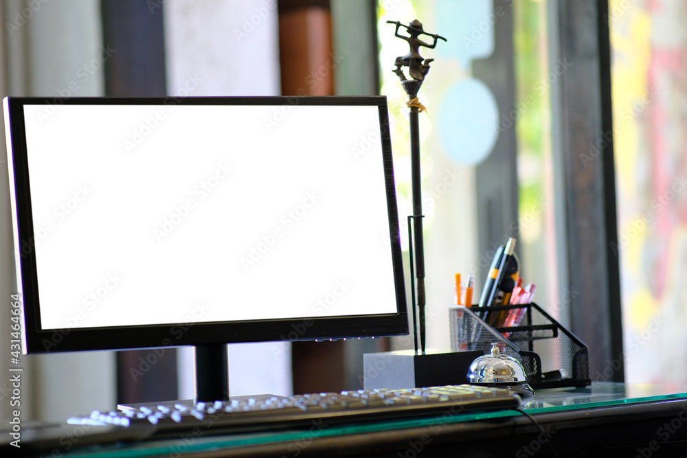 Poster computer on wood table and white screen for text