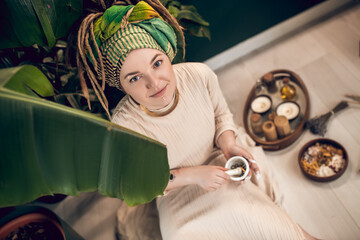 Ayurvedic therapist mixing herbs for medicine preparation