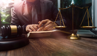 Business and lawyers discussing contract papers with brass scale on desk in office. Law, legal services, advice, justice and law concept picture with film grain effect