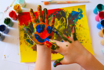 Child painting by finger hand . Ideas for drawing with finger paints. Children development . The...