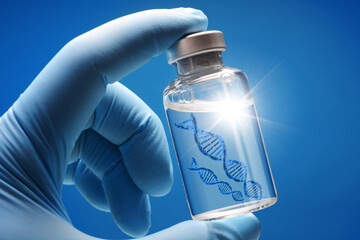 Doctor or scientist shows a vial of genetic agent as a vaccine or therapy against Corona or Covid-19 as a symbolic image - 431467427
