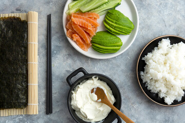 Sushy ingredients fresh salmon filet, basmati rice,avocado, cucumber, cheese cream, cooking suhy at home, step by step.