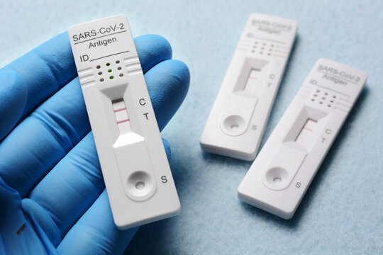 Doctor In A Testing Centre Shows A Rapid Antigen Test With A Positive Result For Corona Or A Covid-19 Infection