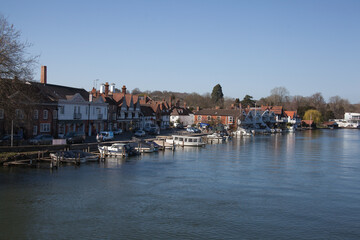 Properties and boats on The Thames in Henley on Thames in Oxfordshire in the UK