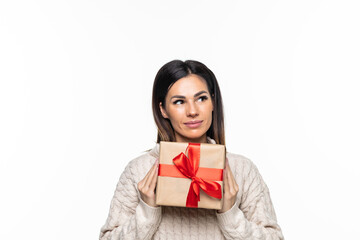 Fototapeta premium Happy pretty young woman holding gift box over gray background