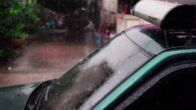 The day was heavy rain, the weather was overcast. Rain drops on the car