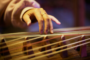 A Close-up of hand and Guzheng - Chinese Horizontal Harp