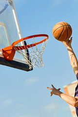 Close-up of a guy throwing a basketball into the basket