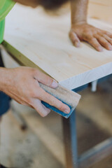close up of hands working on wood