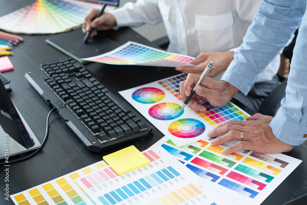 Aufkleber graphic designer or creative working together coloring using graphics tablet and a stylus at desk wi