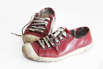old dirty red sports sneakers with laces